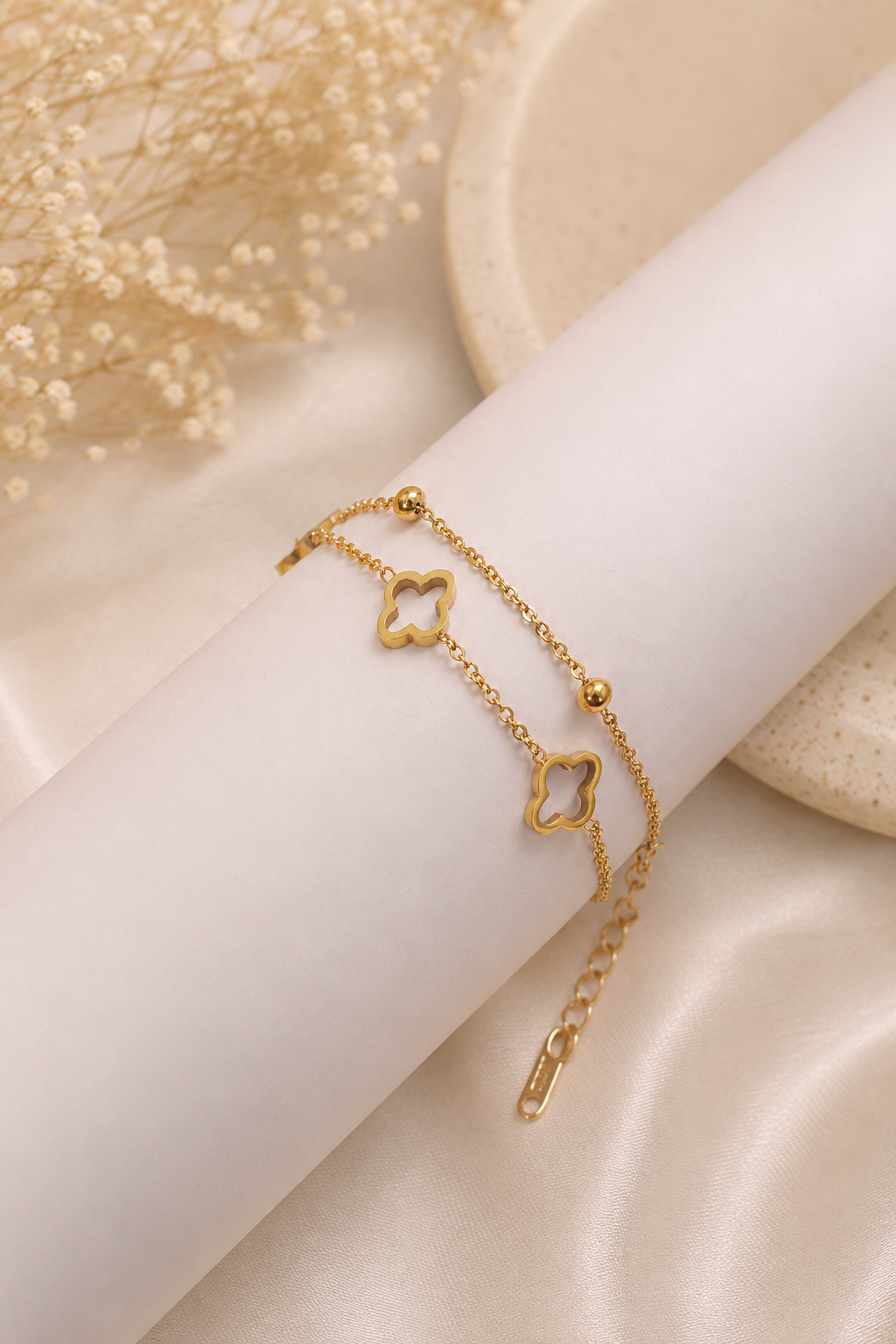 18K gold double chain bracelet featuring polished open clover charms and delicate gold bead accents on a tarnish-free stainless steel chain.