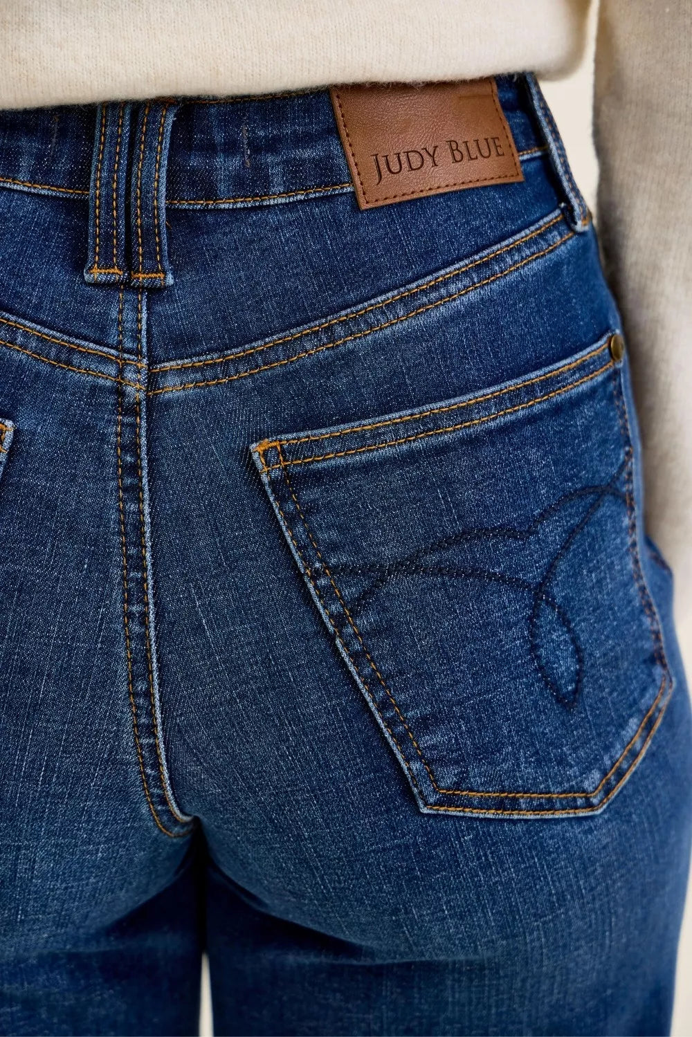 Woman wearing Judy Blue Claudia high waist tummy control ankle wide leg jeans in a dark indigo wash with a flattering modern silhouette. Close View