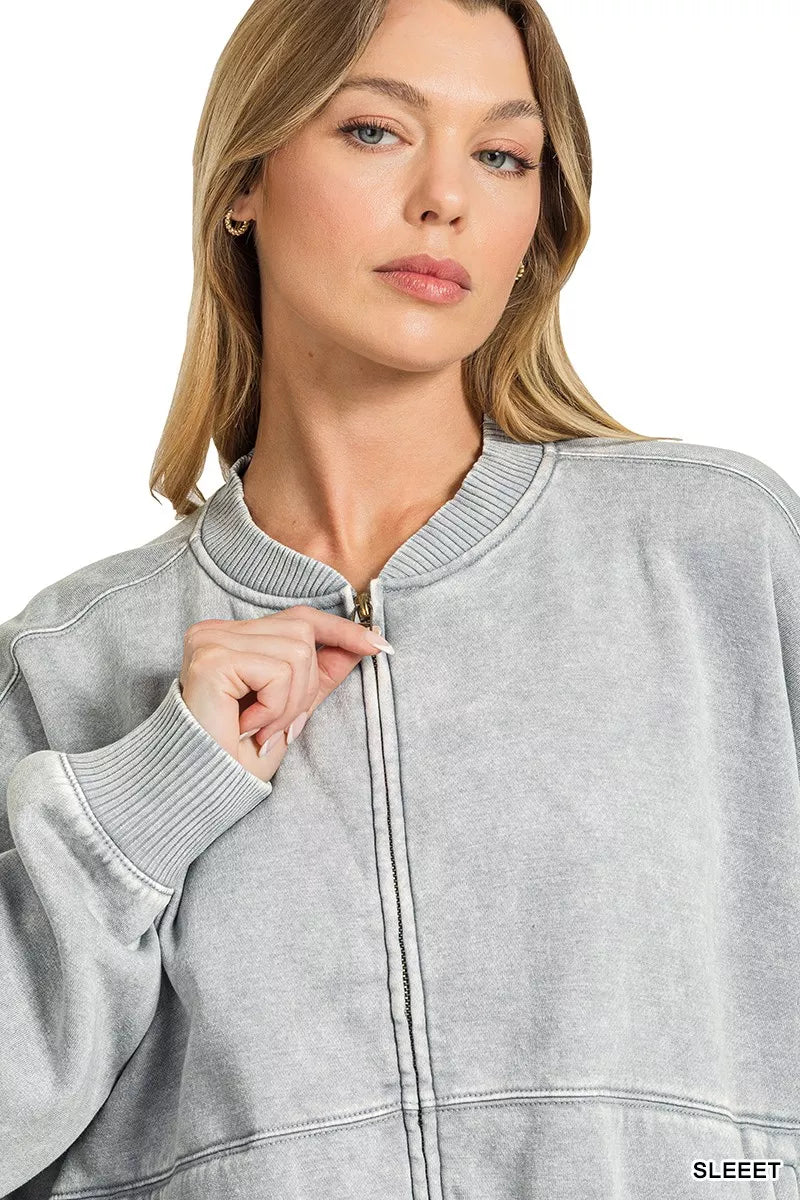 Woman wearing a Sleet acid wash fleece bomber jacket by Zenana featuring a relaxed fit, ribbed trim, zip front and soft vintage washed finish. close view