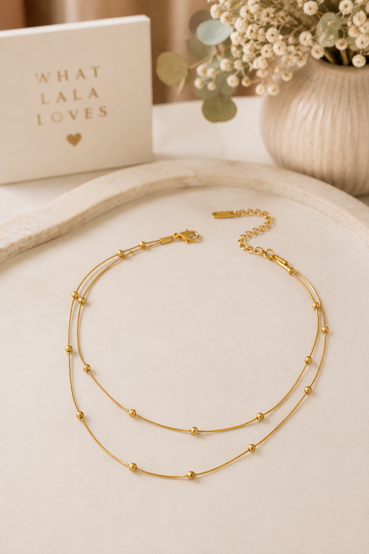 18K gold layered ball station snake chain necklace made from tarnish-free stainless steel with adjustable lobster clasp.