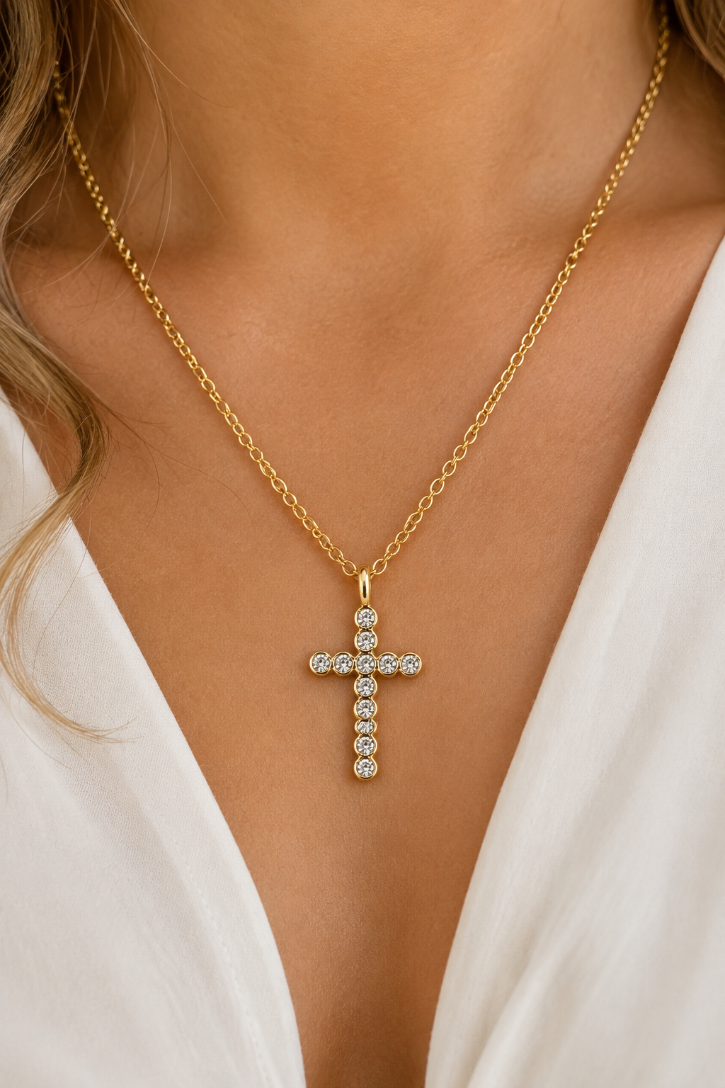 18K gold rhinestone cross necklace featuring a sparkling bezel-set cross pendant on a tarnish-free stainless steel chain. On model