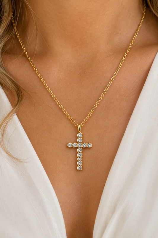 18K gold rhinestone cross necklace featuring a sparkling bezel-set cross pendant on a tarnish-free stainless steel chain. On model