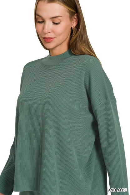 Woman wearing an Ash Jade ribbed two-piece sweater and wide leg pants set by Zenana featuring a relaxed fit and soft viscose knit fabric.