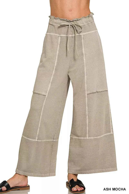 Woman wearing ash mocha washed French terry wide leg pants with exposed seam details, drawstring waist, and relaxed casual fit by Zenana.
