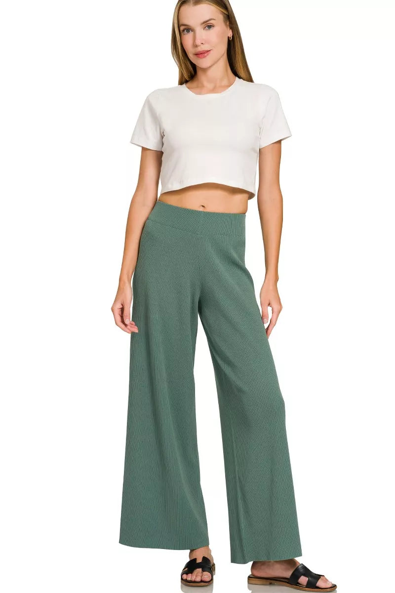 Woman wearing an Ash Jade ribbed two-piece sweater and wide leg pants set by Zenana featuring a relaxed fit and soft viscose knit fabric.