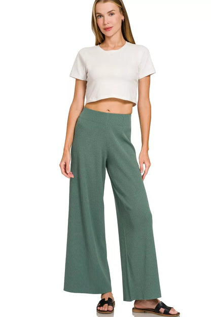 Woman wearing an Ash Jade ribbed two-piece sweater and wide leg pants set by Zenana featuring a relaxed fit and soft viscose knit fabric.