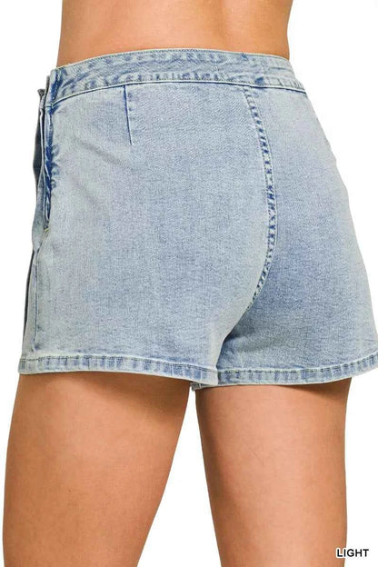 Back view of a Zenana light wash denim wrap skort featuring a button closure, asymmetrical overlap design, mini length, and built-in shorts.