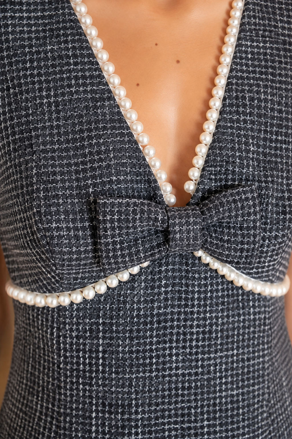 Black tweed mini dress with pearl trim and bow detail by Voy