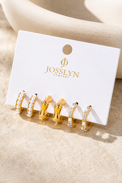 Gold hoop earring trio set featuring pearl huggies, sculptural C-hoops, and baguette crystal hoops.