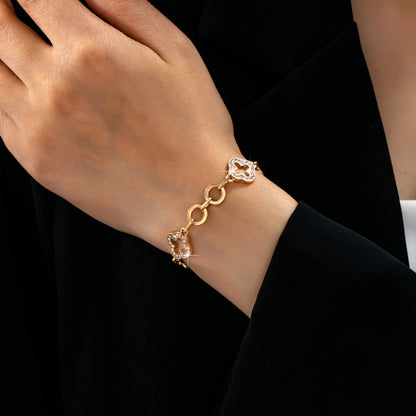 Gold pavé crystal clover link bracelet with toggle clasp featuring sparkling rhinestone quatrefoil charms and polished gold links.