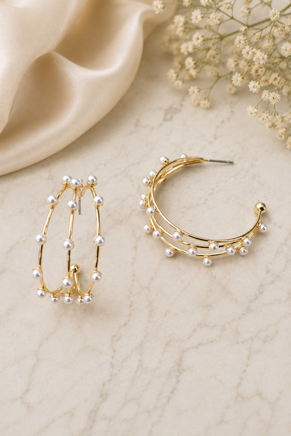 Gold triple row pearl hoop earrings featuring delicate faux pearls on lightweight open hoop posts.