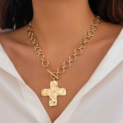 Hammered cross toggle chain necklace with oversized link chain available in gold and silver. On model