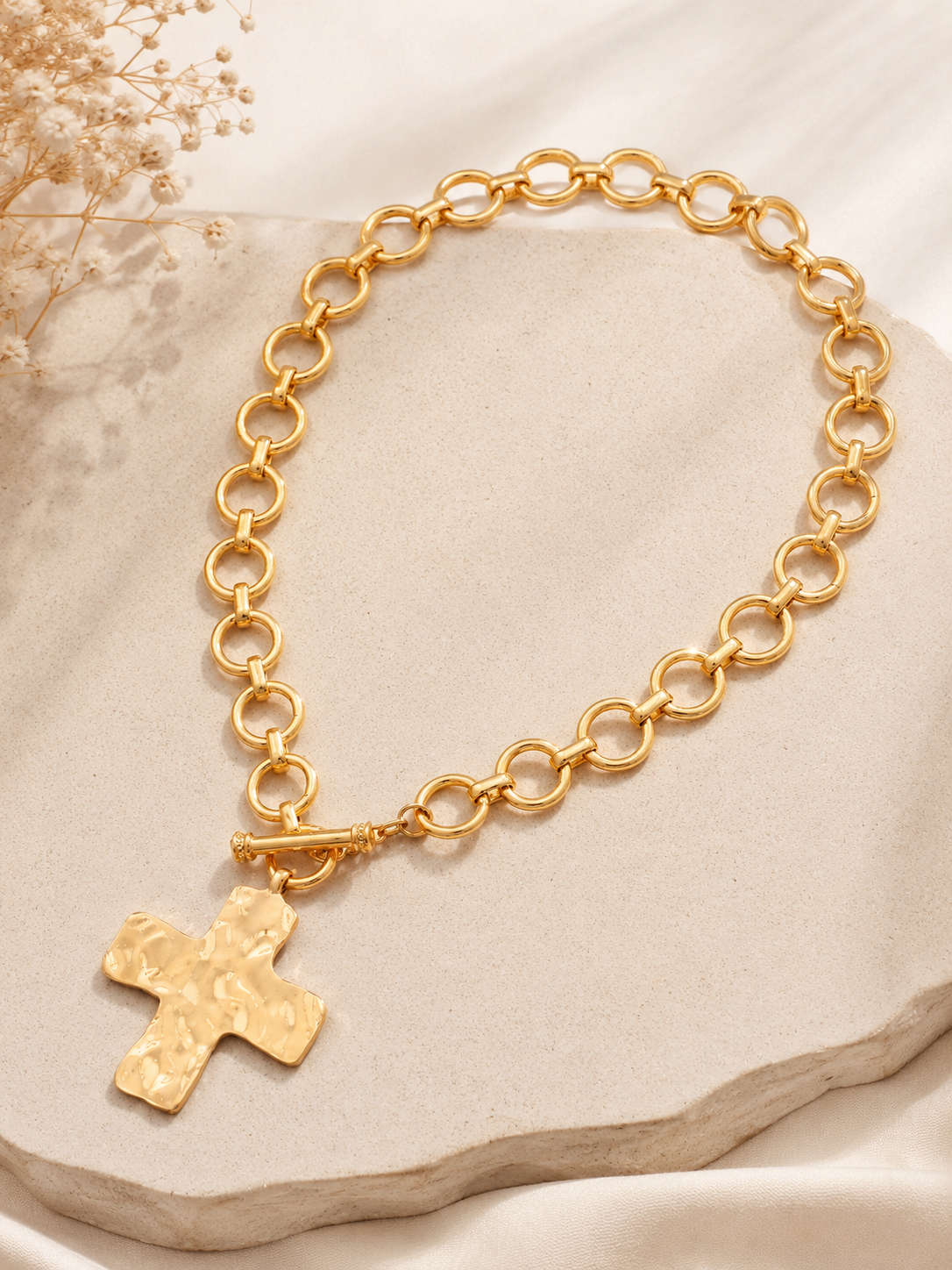 Hammered cross toggle chain necklace with oversized link chain available in gold and silver. Gold Flat Lay