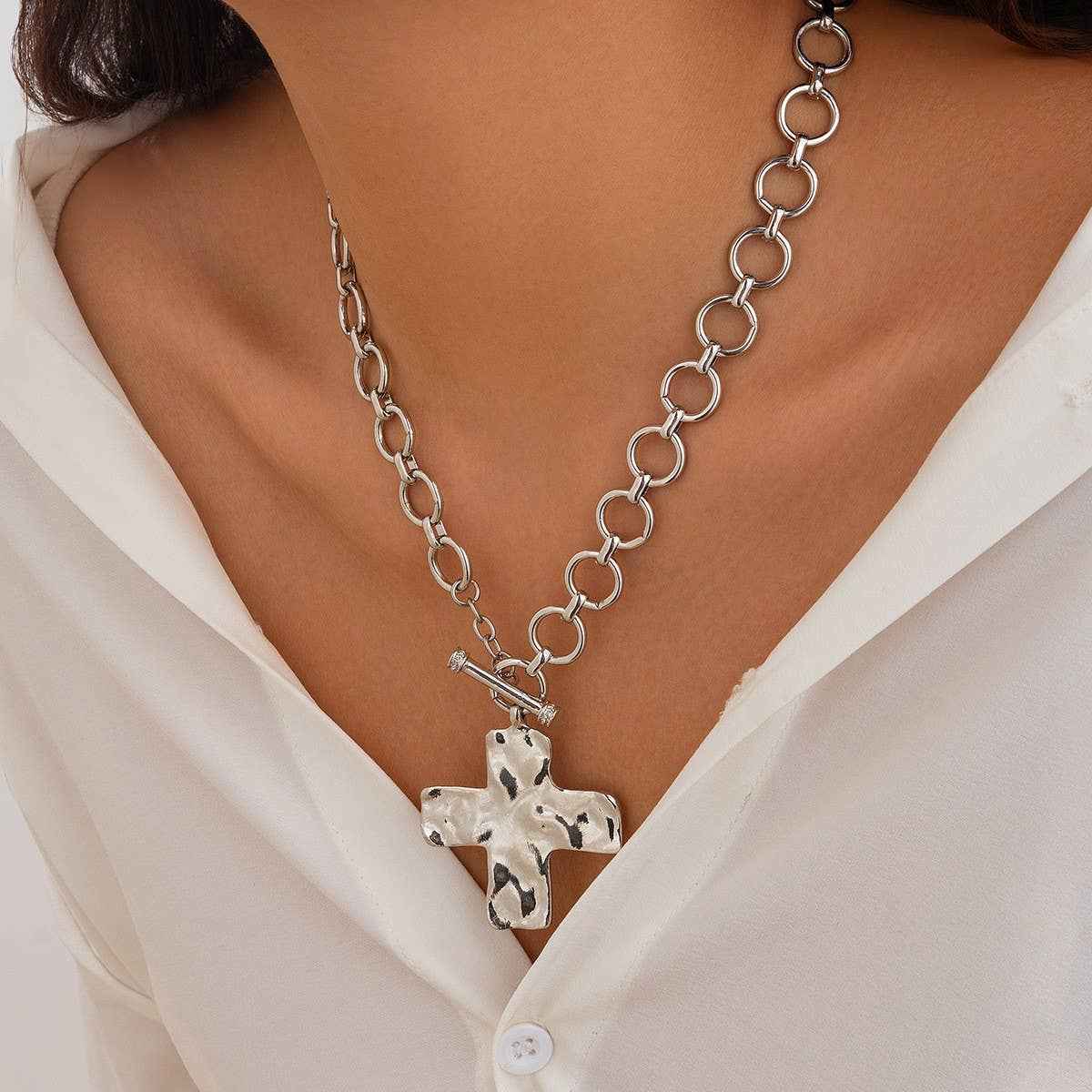 Hammered cross toggle chain necklace with oversized link chain available in gold and silver. On Model