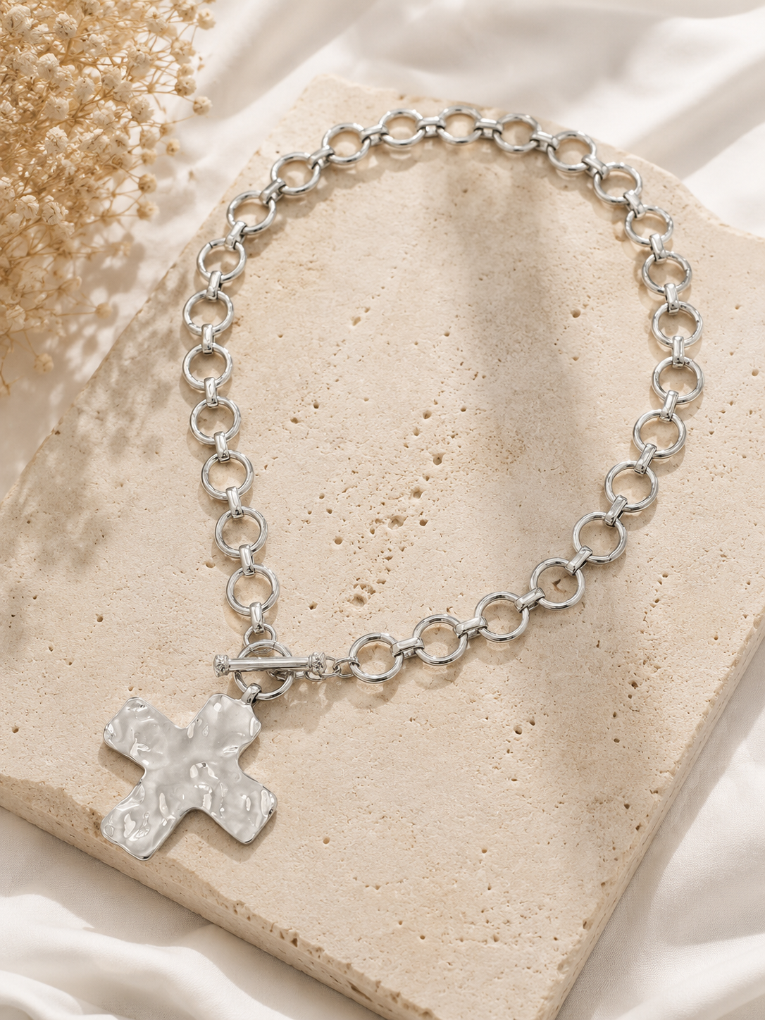 Hammered cross toggle chain necklace with oversized link chain available in gold and silver. Silver Flat Lay