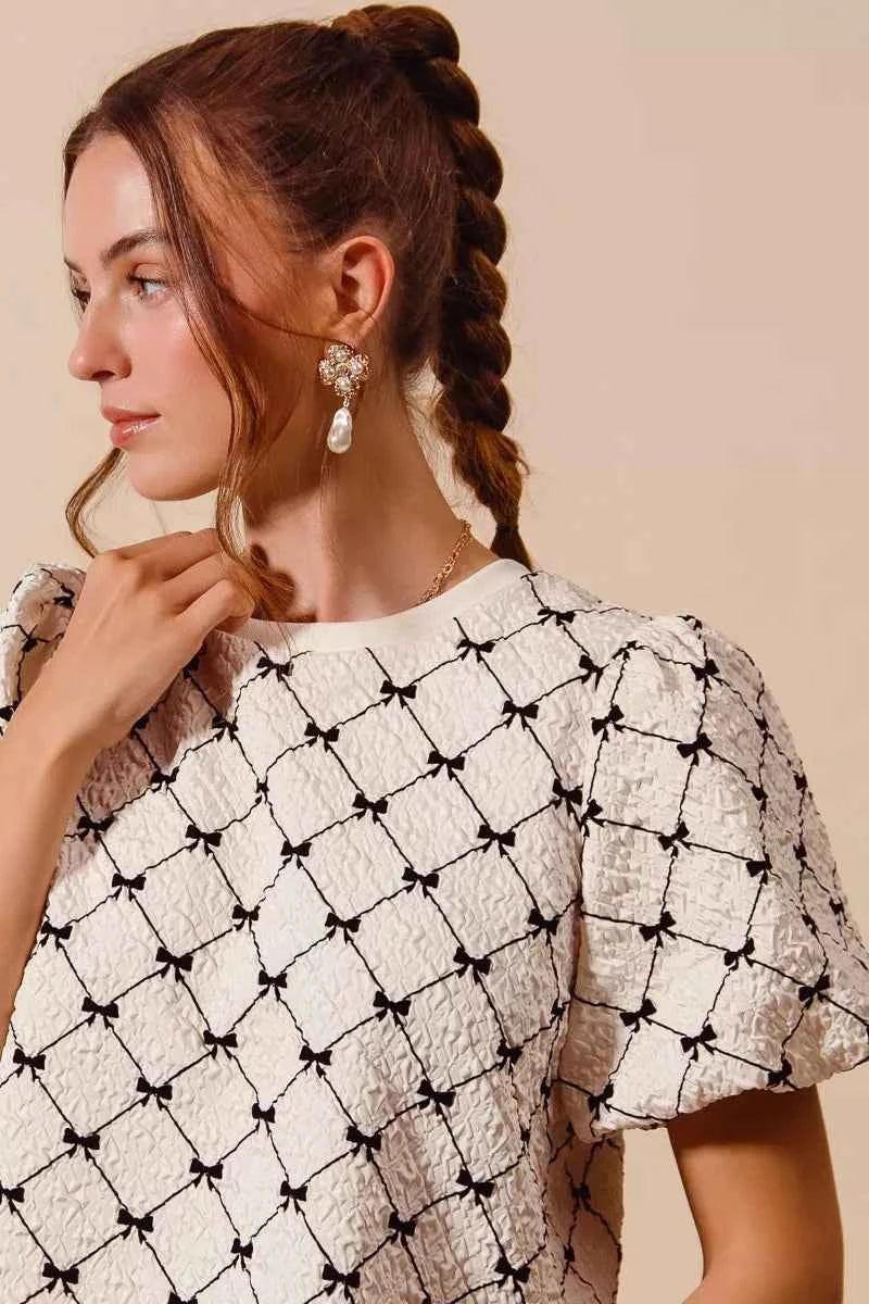 Ivory Bow Texture Woven Bubble Sleeve Top by So Me