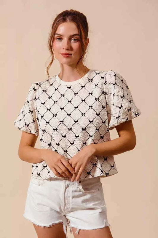 Ivory Bow Texture Woven Bubble Sleeve Top by So Me