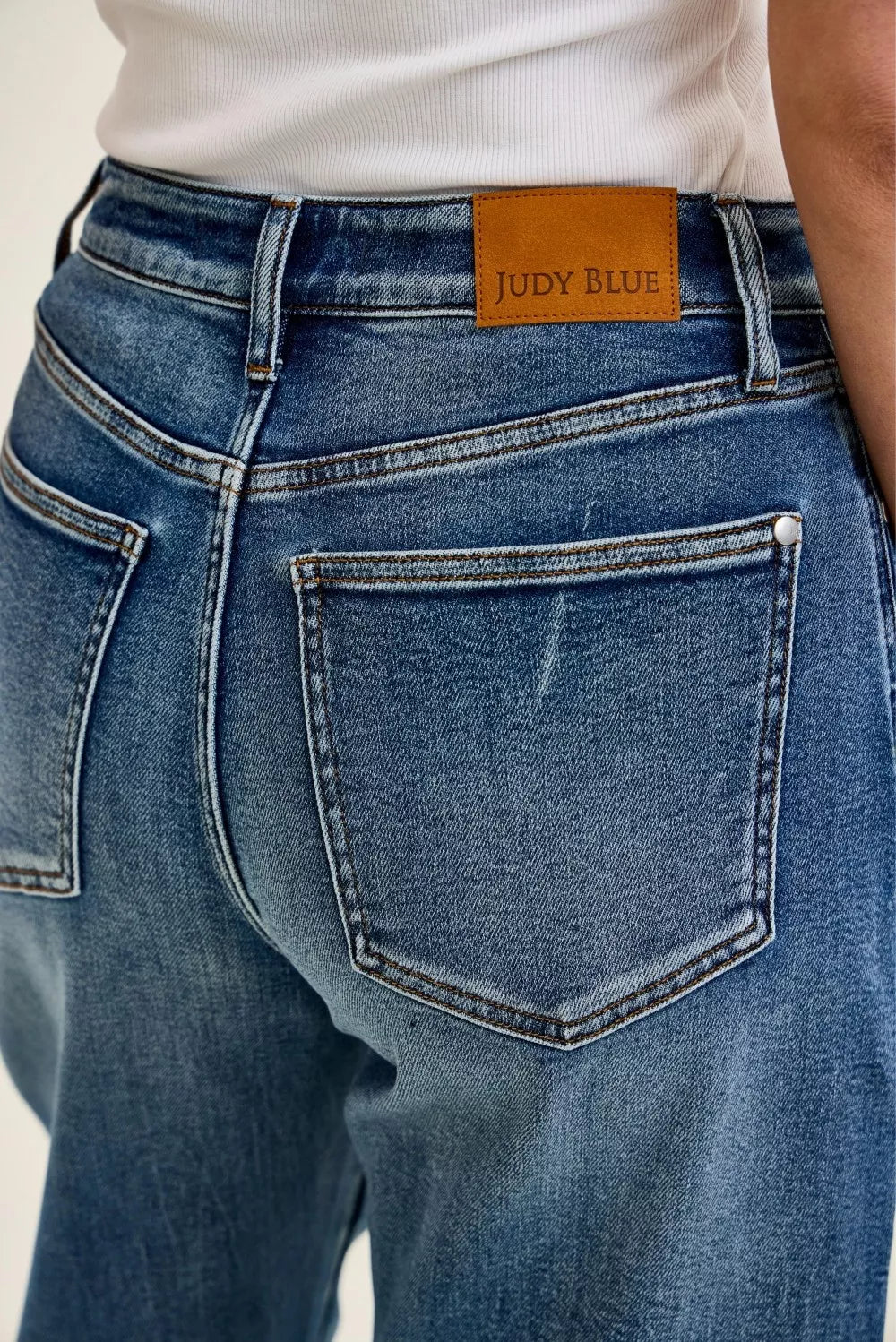 Judy Blue High Waist Marlow Arc Jeans in weathered indigo wash with relaxed arc-leg silhouette and high-rise waist. close view