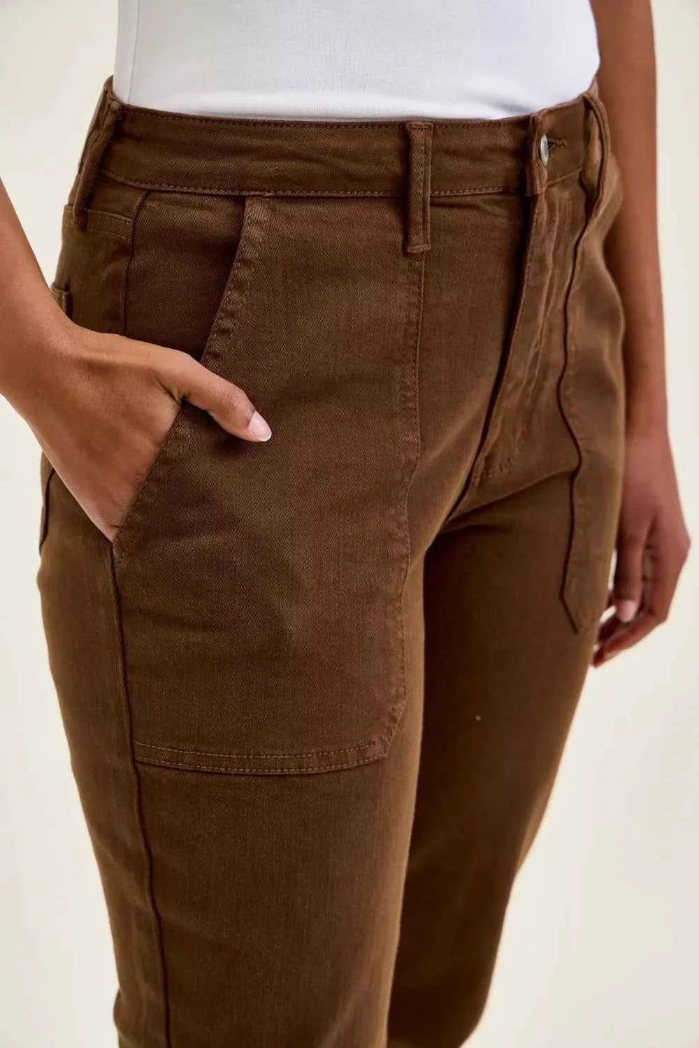 Model wearing Judy Blue Aurora Weekender high waist mahogany jeans with knee dart detailing and ankle-length silhouette. Close View
