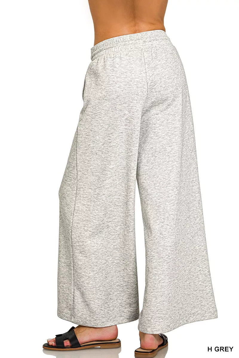 Model wearing Zenana Heather Grey scuba drawstring wide leg pants with pockets and a relaxed modern fit. Back View