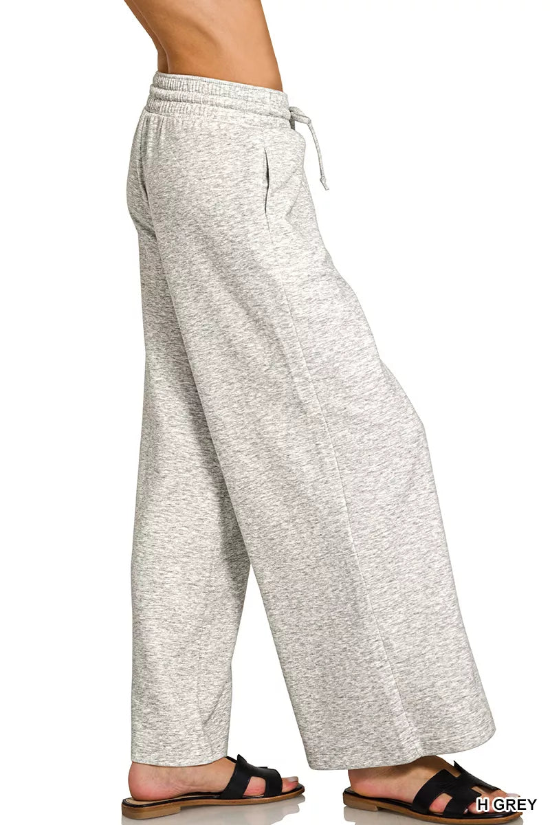 Model wearing Zenana Heather Grey scuba drawstring wide leg pants with pockets and a relaxed modern fit. Side View