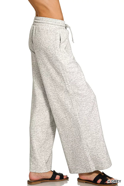 Model wearing Zenana Heather Grey scuba drawstring wide leg pants with pockets and a relaxed modern fit. Side View