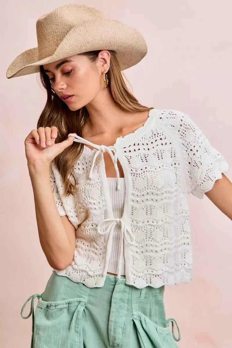 Shop the Ivory Pointelle Front Bow Tie Knit Top by BiBi. Lightweight pointelle knit with feminine bow details for effortless layering and everyday style. Front view 2