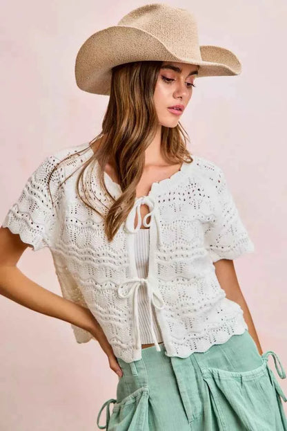Shop the Ivory Pointelle Front Bow Tie Knit Top by BiBi. Lightweight pointelle knit with feminine bow details for effortless layering and everyday style. Front View 4