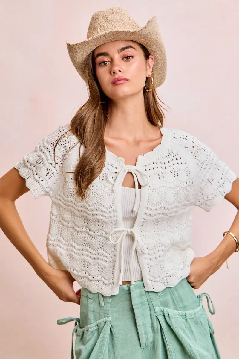 Shop the Ivory Pointelle Front Bow Tie Knit Top by BiBi. Lightweight pointelle knit with feminine bow details for effortless layering and everyday style. Front View 5