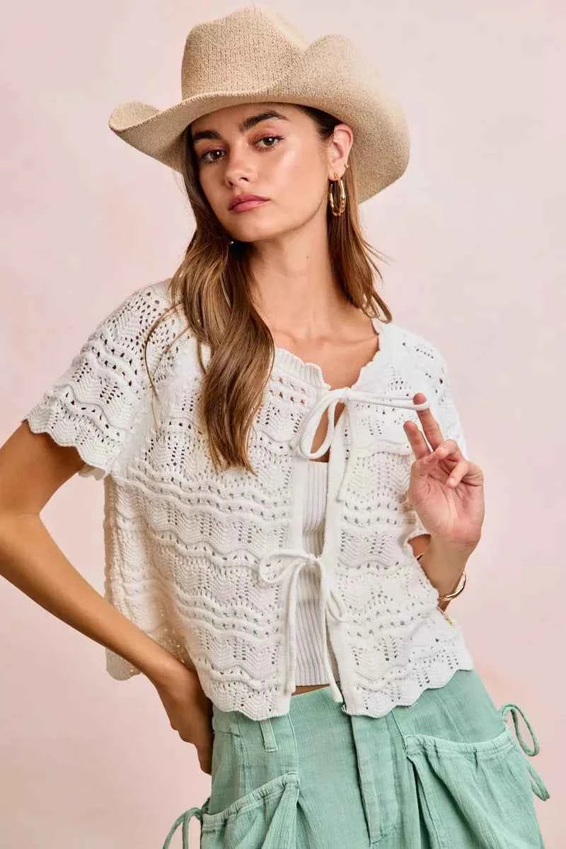 Shop the Ivory Pointelle Front Bow Tie Knit Top by BiBi. Lightweight pointelle knit with feminine bow details for effortless layering and everyday style. Front View 3