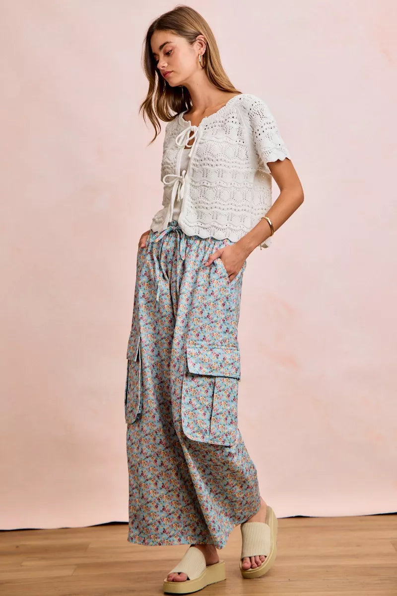 Shop the Ivory Pointelle Front Bow Tie Knit Top by BiBi. Lightweight pointelle knit with feminine bow details for effortless layering and everyday style. Full view