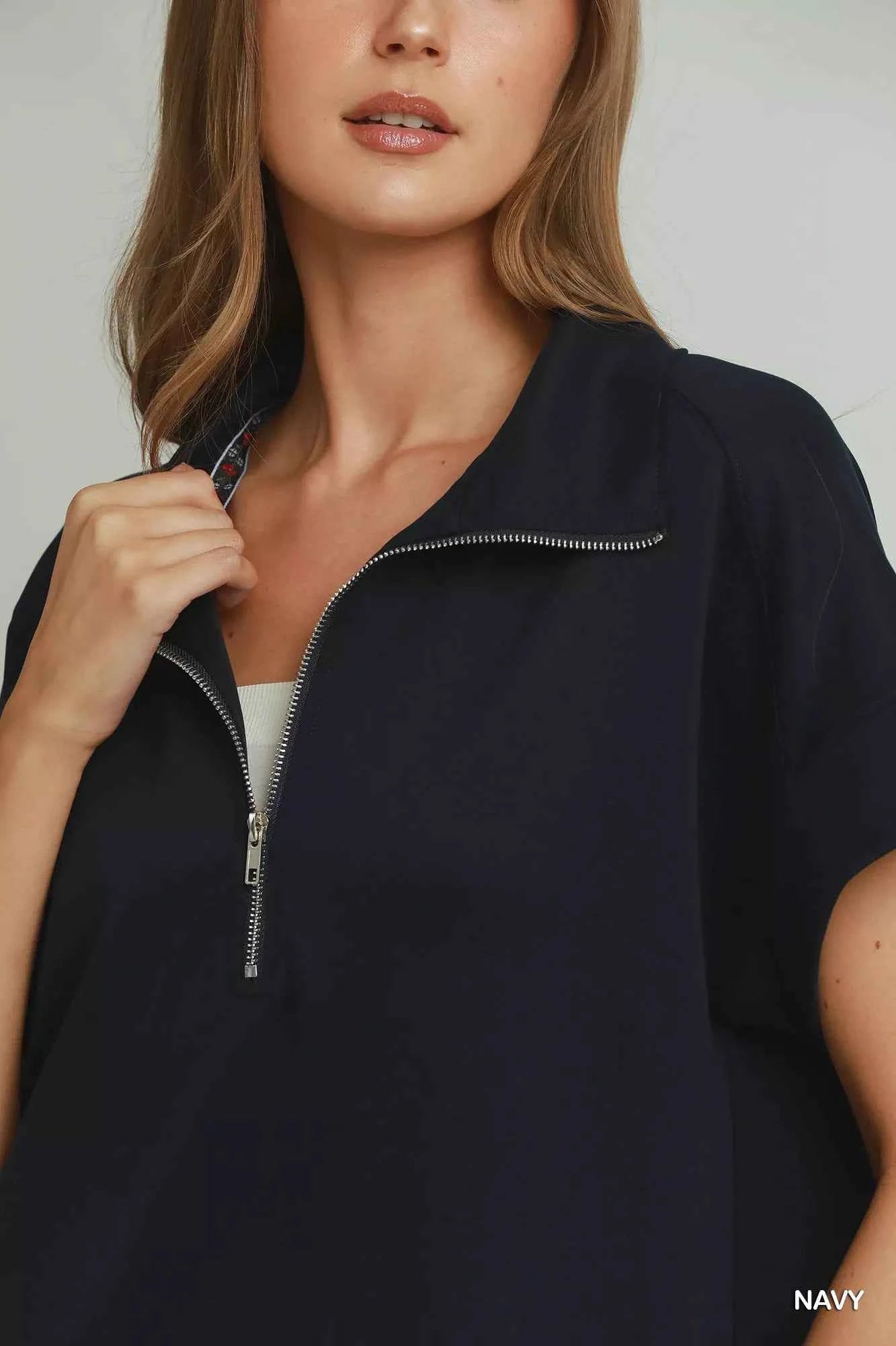 Umgee navy CloudKnit quarter zip mini dress with collar, relaxed fit, side pockets, and soft modal blend fabric styled with casual sneakers. Close view