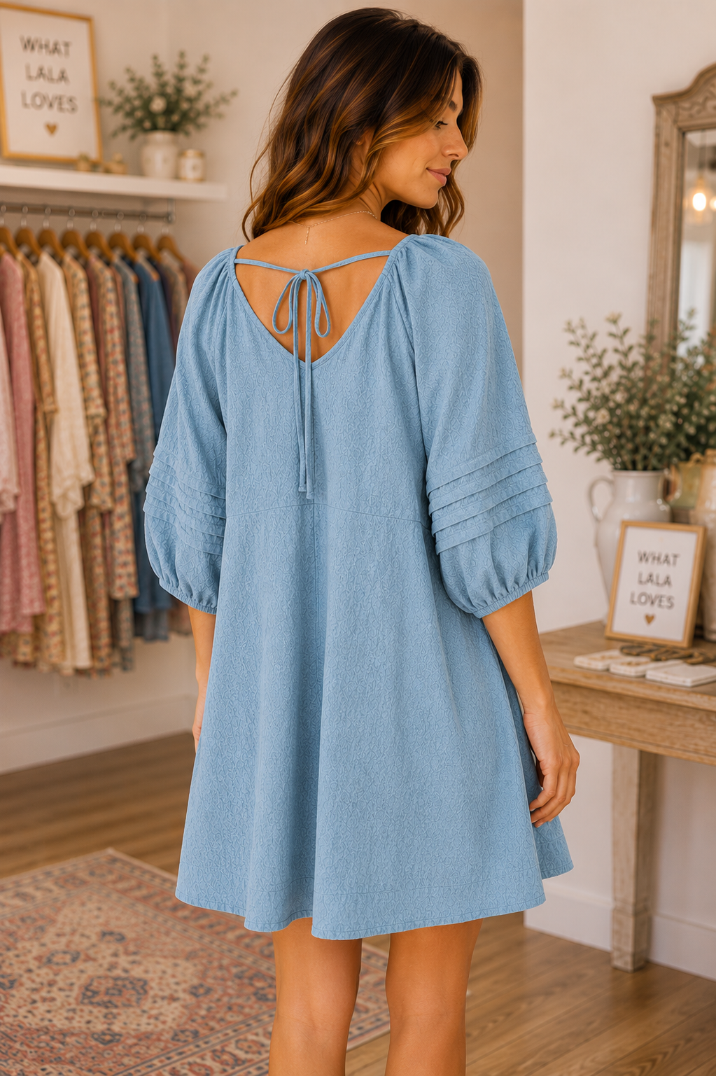 Umgee women's cotton mini dress with V-neckline, puff sleeves, relaxed A-line silhouette and back tie detail dusty blue back view