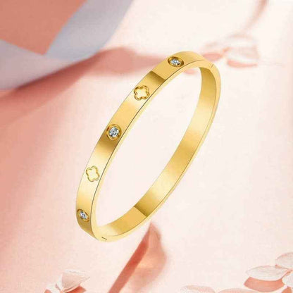 Waterproof stainless steel clover bangle bracelet with rhinestone accents available in 18K gold and silver.