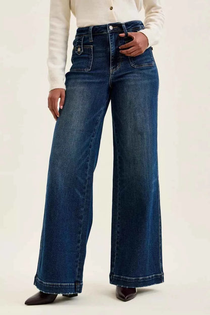 Woman wearing Judy Blue Lux high waist retro wide leg jeans in dark indigo wash with front patch pockets and a vintage-inspired silhouette. Front view
