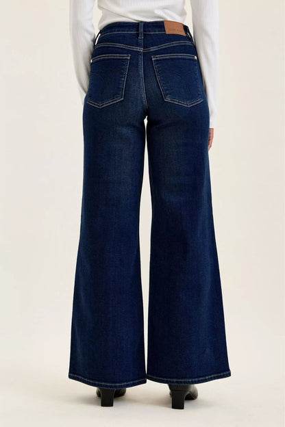 Woman wearing Judy Blue high waist wide leg dark wash jeans with a relaxed silhouette and premium stretch denim.
 Back View