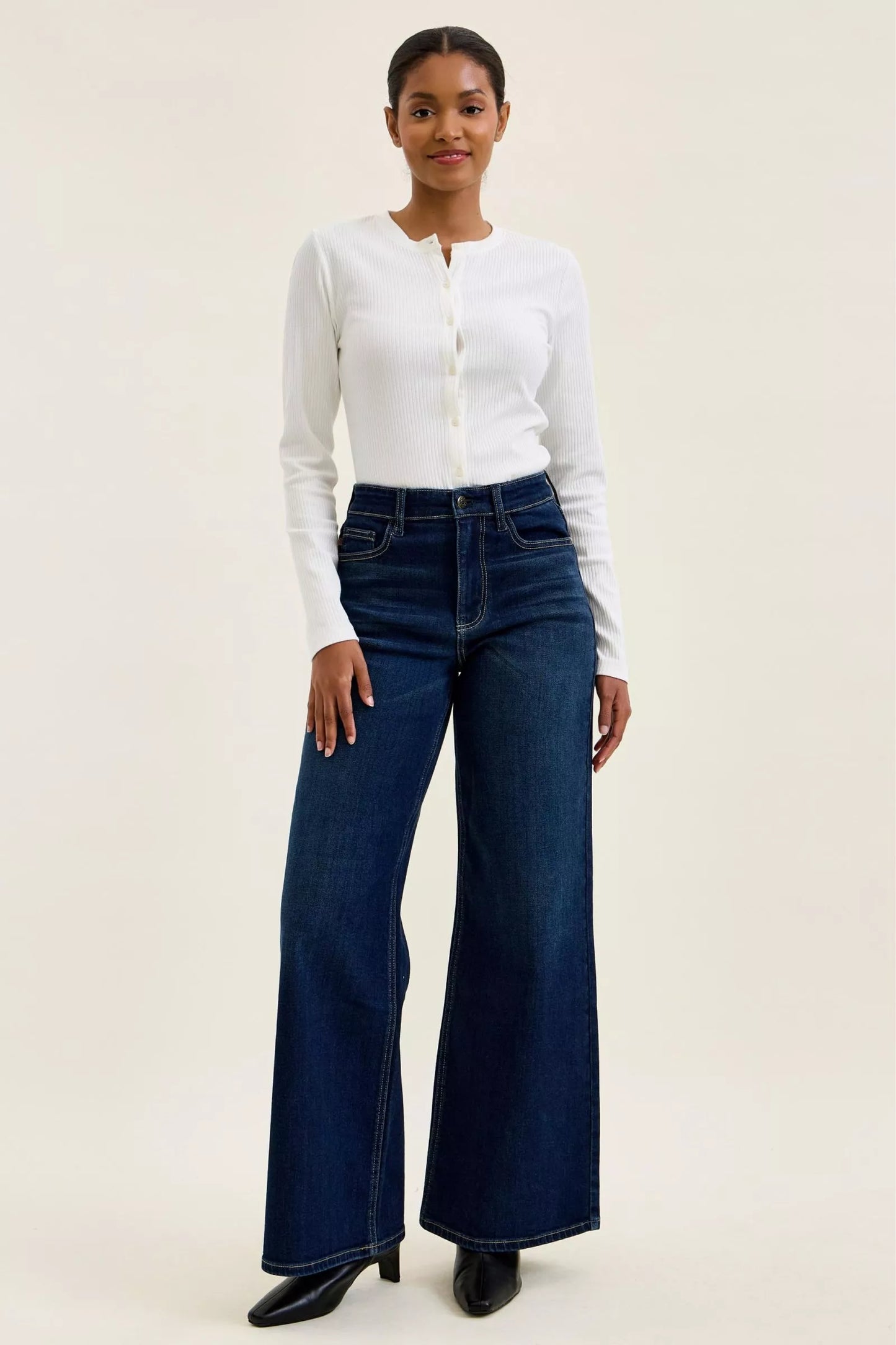 Woman wearing Judy Blue high waist wide leg dark wash jeans with a relaxed silhouette and premium stretch denim.
 full front view