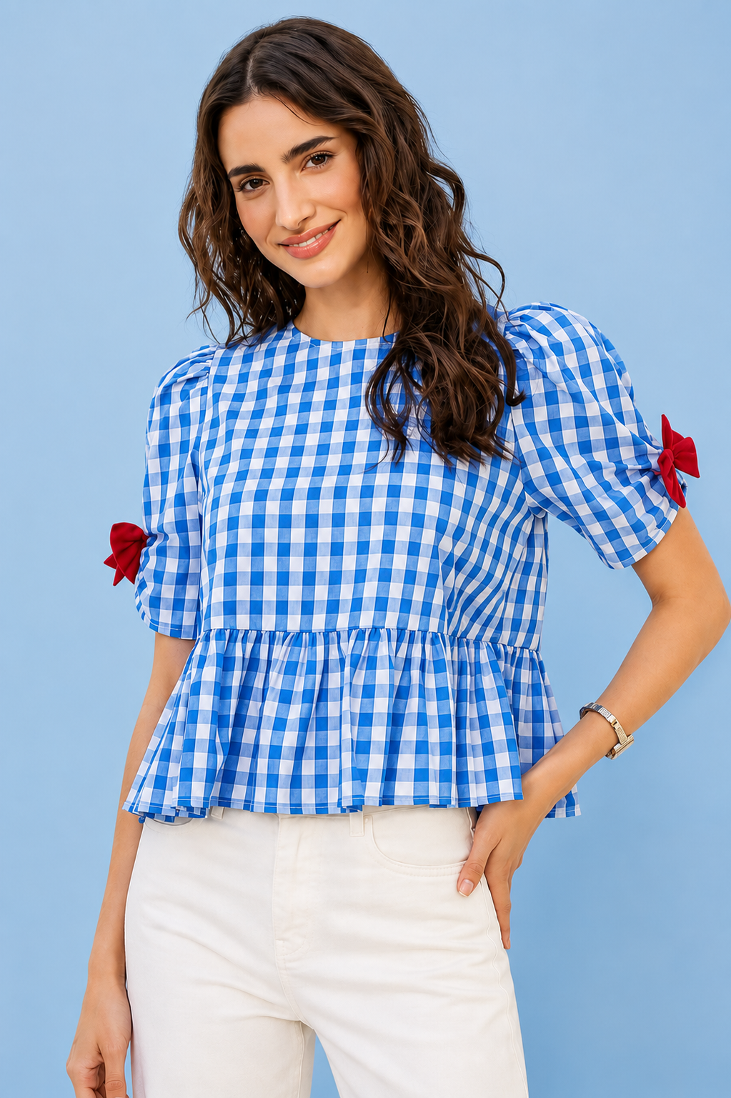 Woman wearing SO ME blue gingham ribbon detail short sleeve blouse featuring bow accents, peplum silhouette, and lightweight summer styling. Front View