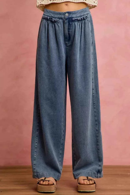 Woman wearing SO ME mid rise wide leg jeans with ruffled front detailing, elastic waistband, and lightweight denim construction.
 Front View