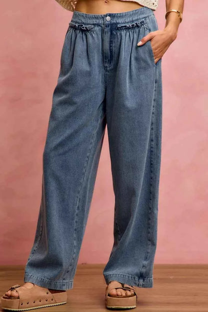 Woman wearing SO ME mid rise wide leg jeans with ruffled front detailing, elastic waistband, and lightweight denim construction.
 Front View 2