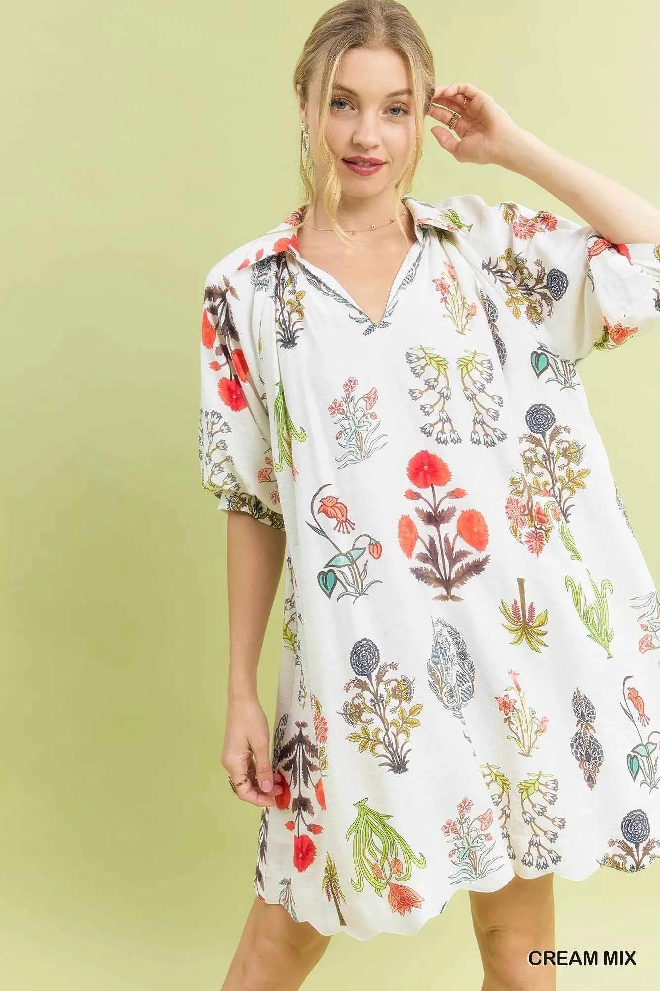 Woman wearing Umgee Cream Botanical Print Mini Dress with pockets, relaxed fit, vintage floral illustrations, and lightweight fabric. Full View