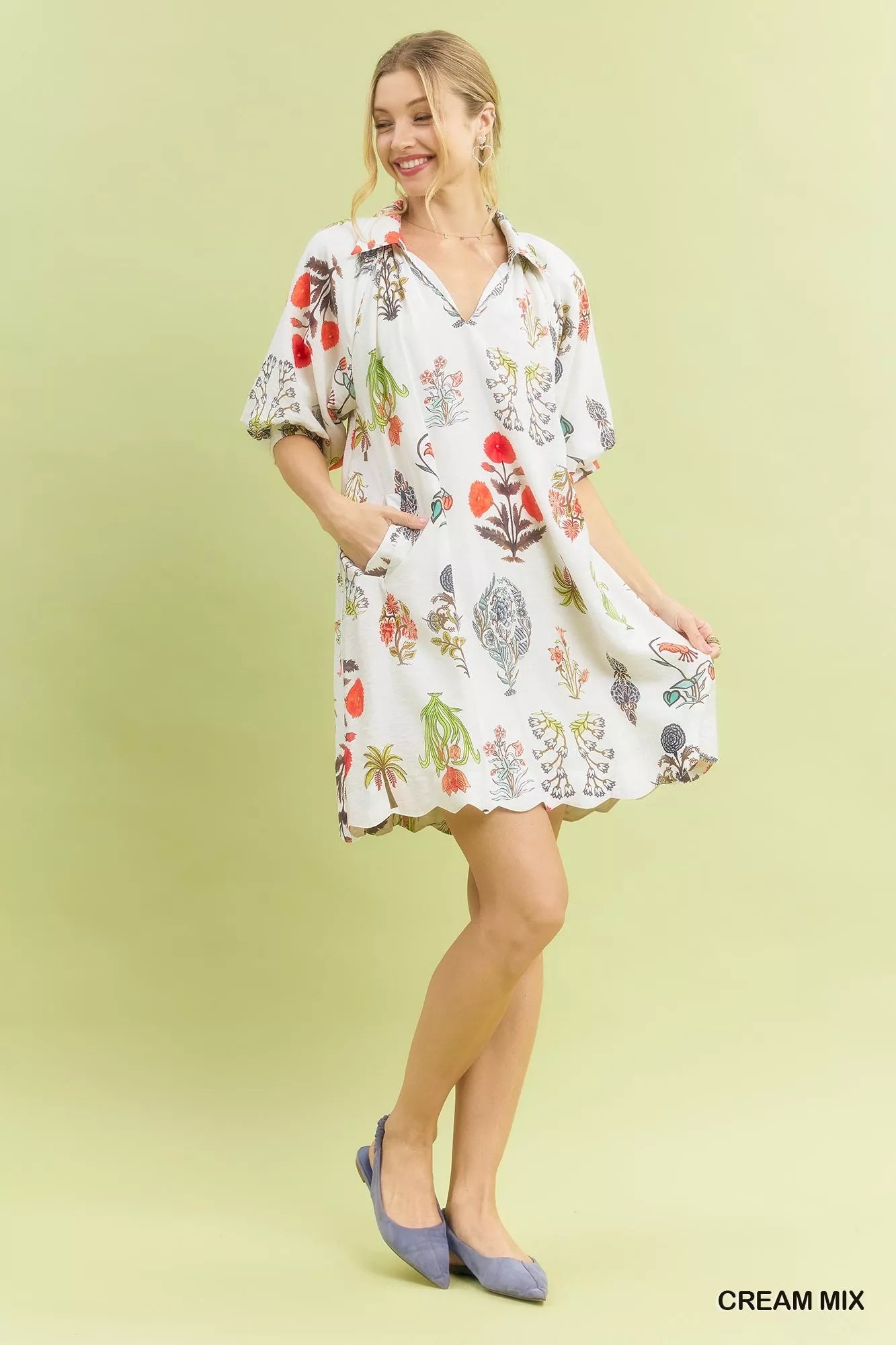 Woman wearing Umgee Cream Botanical Print Mini Dress with pockets, relaxed fit, vintage floral illustrations, and lightweight fabric. Full view