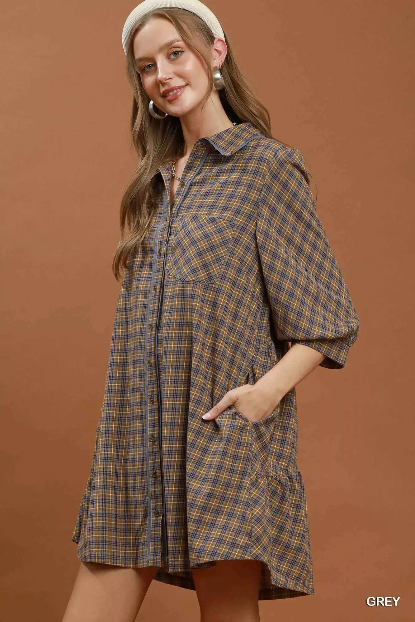 Woman wearing Umgee Grey Plaid Oversized Shirt Dress with button-front closure, chest pocket, collared neckline, and relaxed fit. Side View