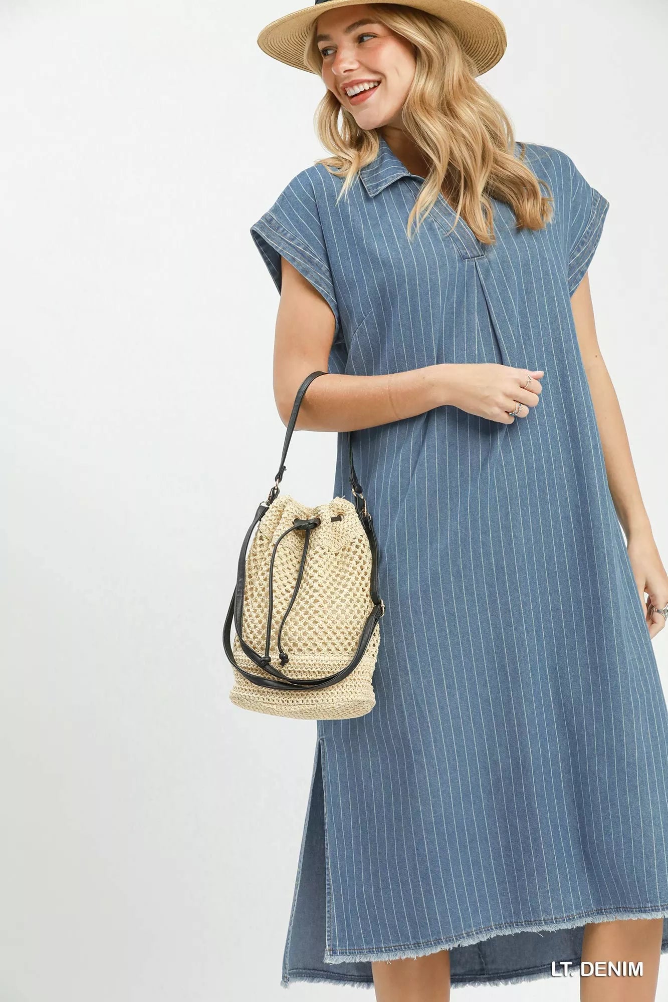 Woman wearing Umgee light denim pinstripe midi dress with collared split neckline, cap sleeves, side pockets, side slits, and raw hem detail.