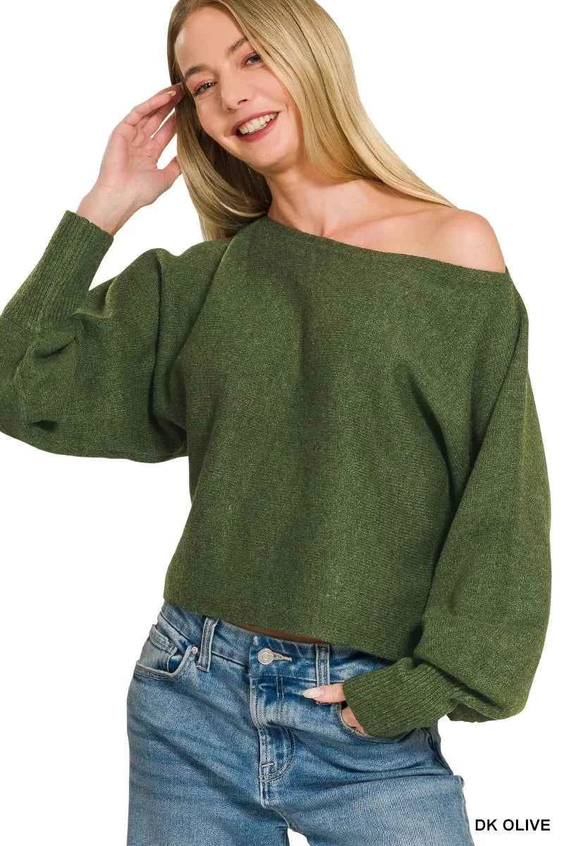 Woman wearing Zenana Dark Olive Boat Neck Balloon Sleeve Sweater with oversized fit and ribbed cuffs paired with denim jeans. Front View