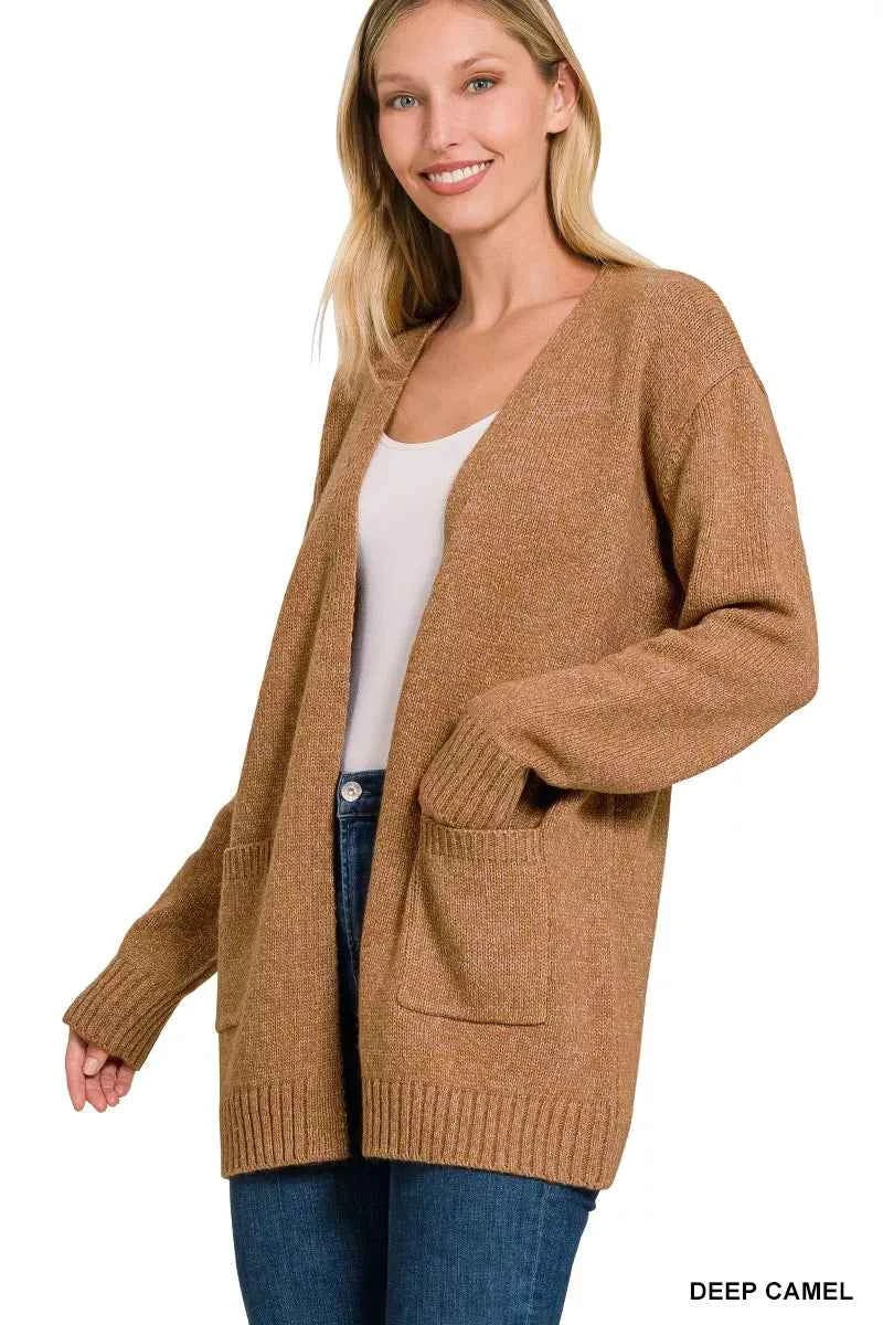 Woman wearing Zenana deep camel open front lightweight knit cardigan with front pockets and ribbed trim. Side View