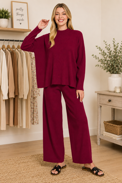 Woman wearing a Cabernet ribbed viscose two-piece lounge set featuring a relaxed sweater top and wide-leg pants by Zenana. front view