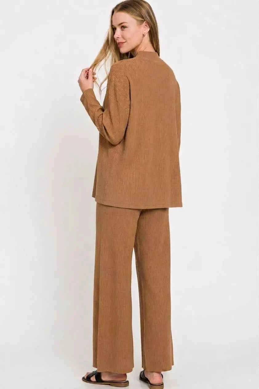 Woman wearing a Deep Camel ribbed viscose two-piece lounge set with a relaxed sweater top and wide-leg pants by Zenana. Back View