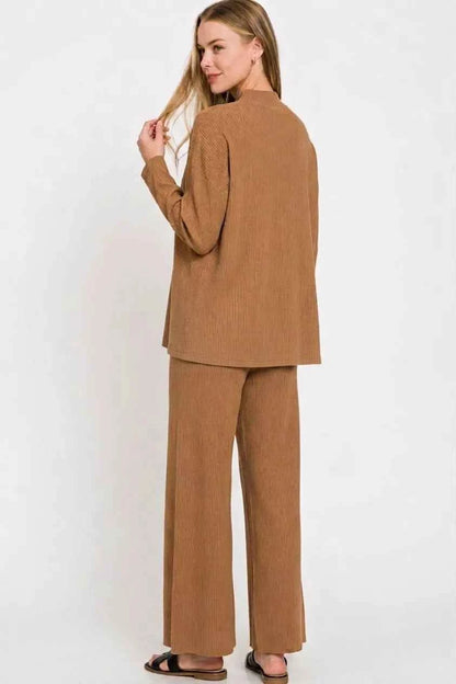 Woman wearing a Deep Camel ribbed viscose two-piece lounge set with a relaxed sweater top and wide-leg pants by Zenana. Back View
