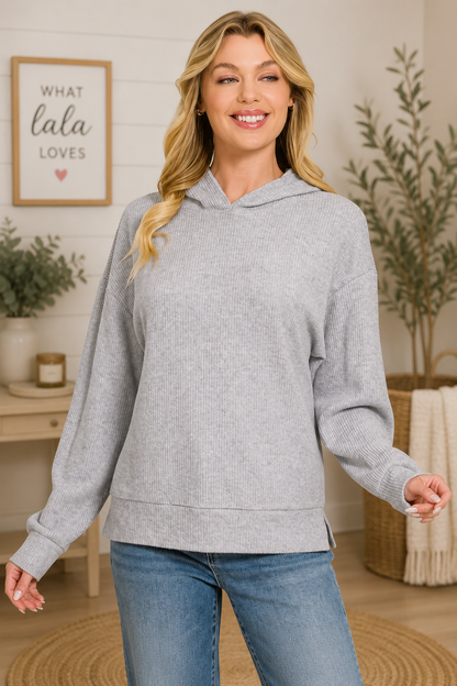Woman wearing a Heather Grey brushed ribbed hacci knit hoodie with long sleeves and a relaxed fit by Zenana. Front View
